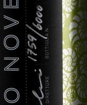 Green olive oil bottle featuring a decorative label with black and white design elements. - Olive Oil Times