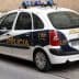 A Spanish police car with blue lights and 'Policía' written on the side parked on a street. - Olive Oil Times