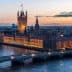 Houses of Parliament and Big Ben illuminated at sunset over the River Thames in London. - Olive Oil Times