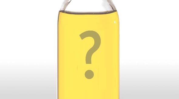 Transparent bottle filled with yellow oil featuring a large question mark in the center. - Olive Oil Times