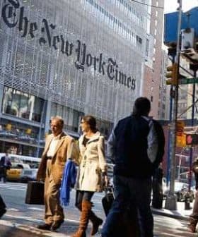 The exterior of The New York Times building with its name displayed prominently on the facade. - Olive Oil Times