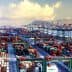 Aerial view of a busy container port filled with cargo containers and cranes. - Olive Oil Times