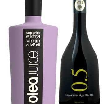 Two bottles of extra virgin olive oil, one with a purple label and the other with a black label. - Olive Oil Times