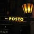 Illuminated sign reading 'Del Posto' with a lantern above it. - Olive Oil Times