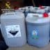 Several containers labeled as corrosive substance, stacked together with a warning symbol. - Olive Oil Times