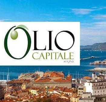 Logo of Olio Capitale Expo displayed over a coastal city view with boats and buildings. - Olive Oil Times