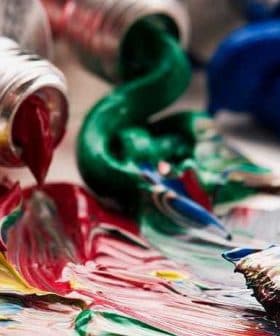 Opened paint tubes with red, green, blue, and yellow paint squeezed out onto a surface. - Olive Oil Times