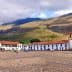 Colonial buildings with red roofs and cobblestone plaza in a mountainous region of Colombia. - Olive Oil Times