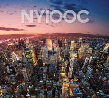 Aerial view of New York City skyline during sunset with vibrant colors in the sky. - Olive Oil Times