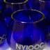 Set of cobalt blue glasses featuring the NYIOOC logo on the front. - Olive Oil Times