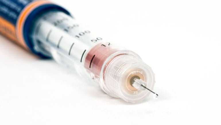 Close-up of an insulin syringe showing the needle and measurement markings. - Olive Oil Times