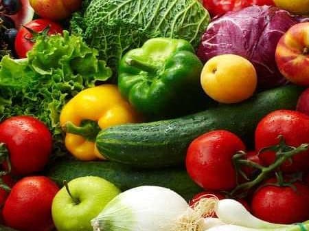 A variety of fresh vegetables and fruits including peppers, tomatoes, cucumbers, and leafy greens. - Olive Oil Times