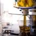 Machine filling plastic bottles with olive oil during the bottling process in a factory. - Olive Oil Times