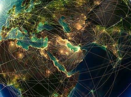 Digital representation of the Earth with illuminated connections across continents and oceans. - Olive Oil Times
