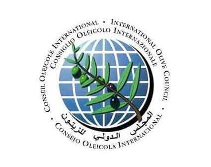Logo of the International Olive Council featuring an olive branch and globe design. - Olive Oil Times