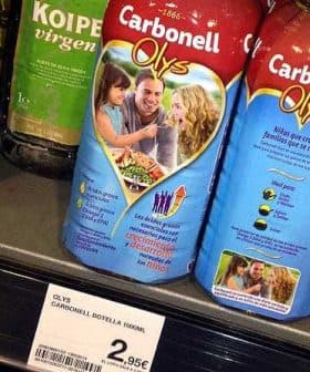 Carbonell Olys olive oil bottle displayed on a store shelf with price tag. - Olive Oil Times