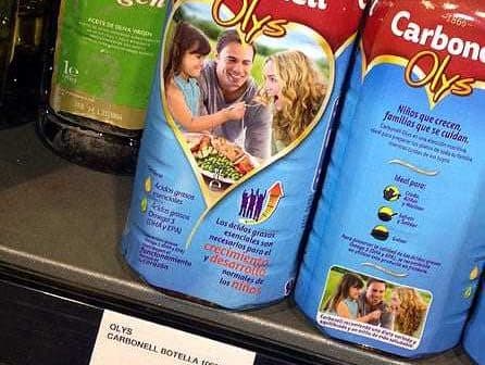 Carbonell Olys olive oil bottle displayed on a store shelf with price tag. - Olive Oil Times