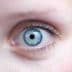 Close-up image of a human eye featuring a blue iris and dark pupil. - Olive Oil Times