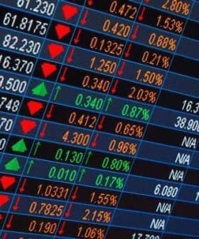 Stock market ticker displaying various stock prices with green and red indicators for changes. - Olive Oil Times