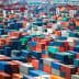 Aerial view of numerous shipping containers stacked in various colors at a port facility. - Olive Oil Times