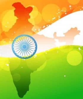 Graphic representation of the map of India in national flag colors with the Ashoka Chakra in the center. - Olive Oil Times