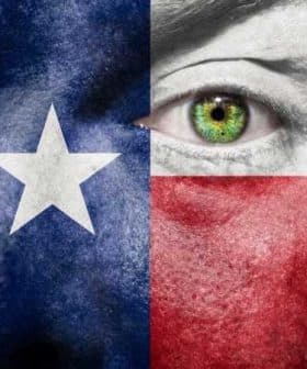 Close-up of a face painted with the Texas flag colors, featuring a green eye. - Olive Oil Times