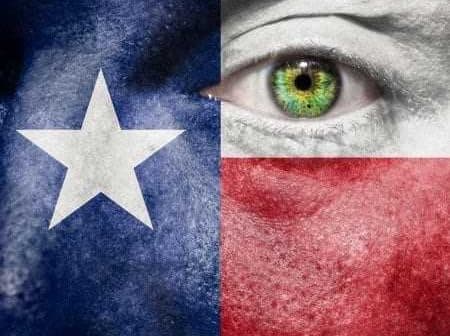 Close-up of a face painted with the Texas flag colors, featuring a green eye. - Olive Oil Times