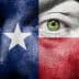 Close-up of a face painted with the Texas flag colors, featuring a green eye. - Olive Oil Times