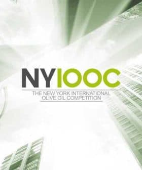 Logo for the New York International Olive Oil Competition featuring text and a cityscape design. - Olive Oil Times