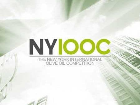 Logo for the New York International Olive Oil Competition featuring text and a cityscape design. - Olive Oil Times