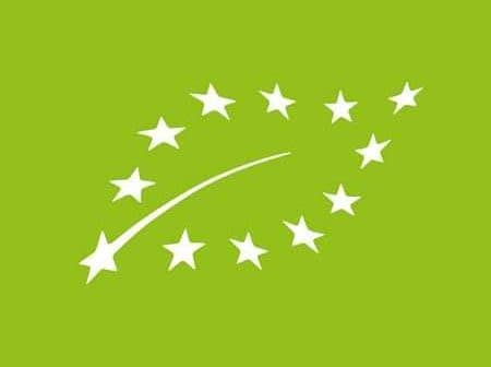 Logo representing European organic certification with stars and a curved line on a green background. - Olive Oil Times