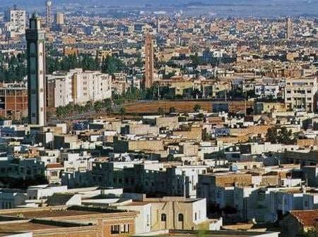 A panoramic view of Oujda, Morocco, featuring various buildings and structures in the landscape. - Olive Oil Times
