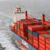 A large container ship with stacked cargo containers navigating through the ocean. - Olive Oil Times