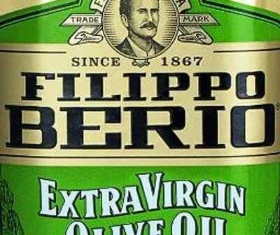 Bottle of Filippo Berio Extra Virgin Olive Oil featuring a green label and a portrait of a man. - Olive Oil Times