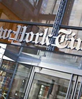 Entrance sign of The New York Times building with the name displayed prominently. - Olive Oil Times