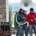 Three musicians performing outdoors with a tuba, trumpet, and other instruments. - Olive Oil Times