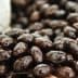 Close-up view of shiny black olives displayed in a natural setting. - Olive Oil Times