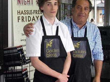 Two individuals wearing store uniforms with the logo 'Golden Bless' standing together in a retail environment. - Olive Oil Times