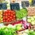 Display of fresh vegetables including tomatoes, green beans, and lettuce at a market stall. - Olive Oil Times
