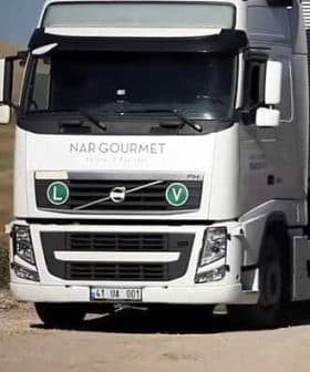 White Volvo truck with Nargourmet branding and green circular symbols on the front. - Olive Oil Times