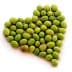 A collection of green olives arranged in the shape of a heart on a white background. - Olive Oil Times