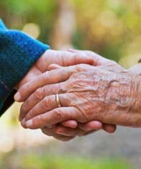 Two hands, one older and one younger, clasped together in a gesture of connection. - Olive Oil Times