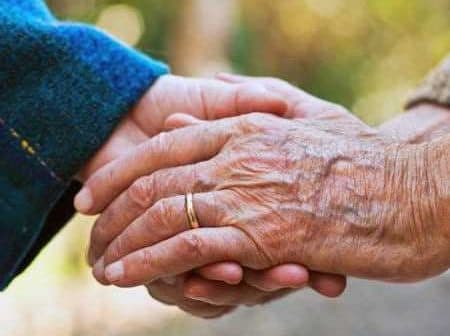 Two hands, one older and one younger, clasped together in a gesture of connection. - Olive Oil Times