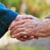 Two hands, one older and one younger, clasped together in a gesture of connection. - Olive Oil Times