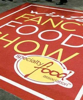 Red carpet with the text 'Winter Fancy Food Show' and 'Specialty Food Association' in yellow and white. - Olive Oil Times