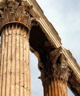 Close-up view of ancient Greek columns featuring Corinthian capitals and weathered stone. - Olive Oil Times