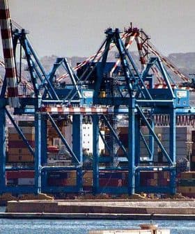 Loading cranes at a port with stacked shipping containers in the foreground. - Olive Oil Times