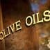Close-up view of a sign that reads 'Olive Oils' in gold lettering on a dark background. - Olive Oil Times