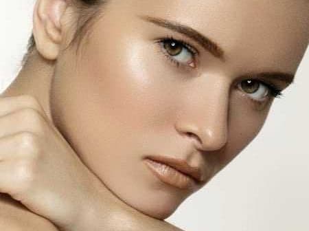 Close-up portrait of a woman with light skin and green eyes, looking directly at the camera. - Olive Oil Times