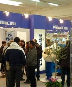 Piaralisi exhibition booth with attendees interacting at a trade show event. - Olive Oil Times